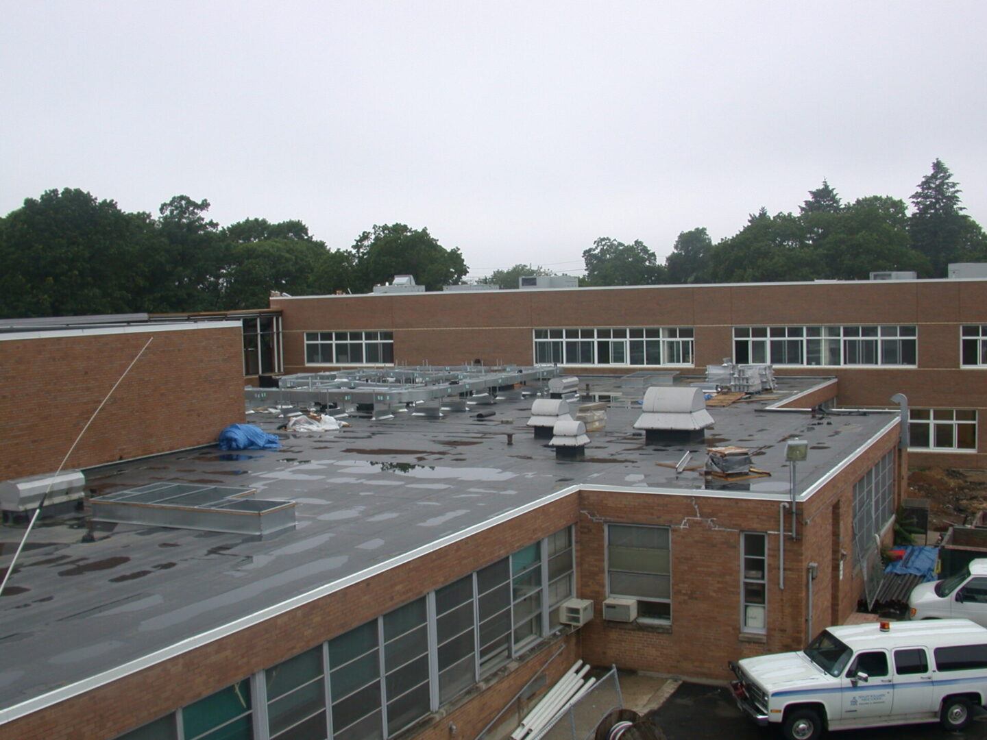 A large building with some windows and a truck parked on the side of it.