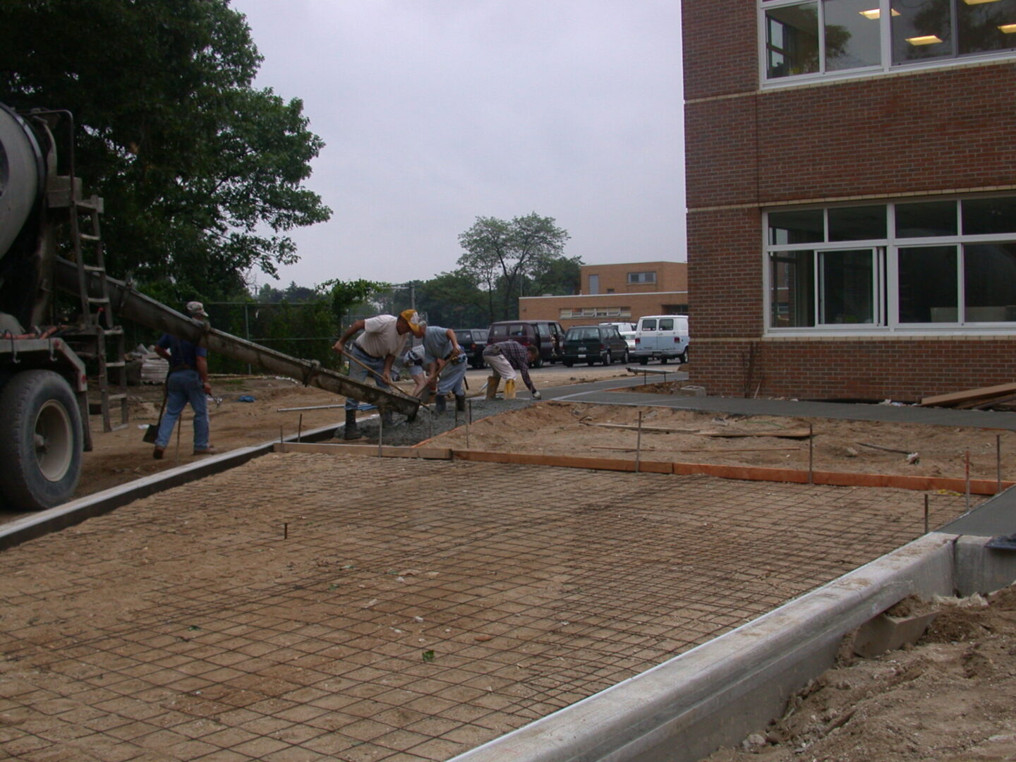 A group of people standing around a building.