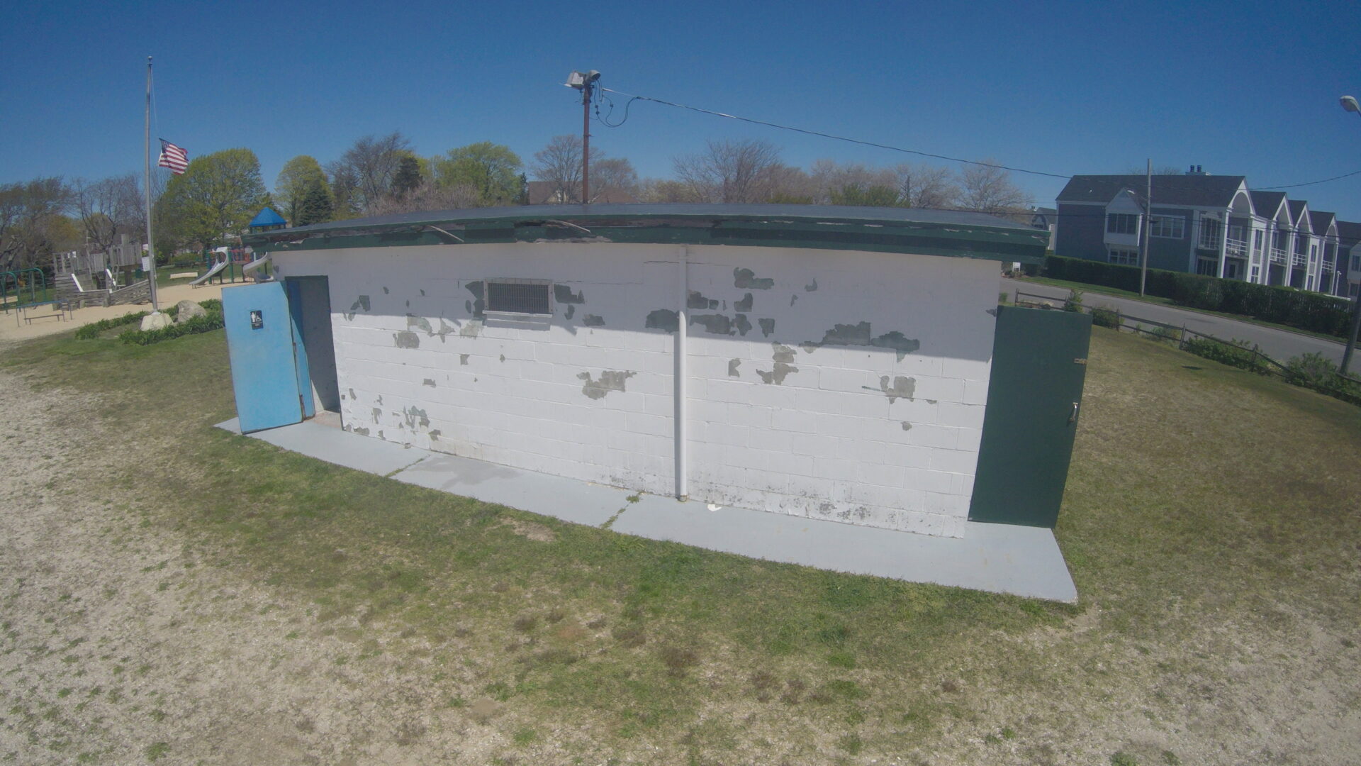 A large concrete wall with holes in it.