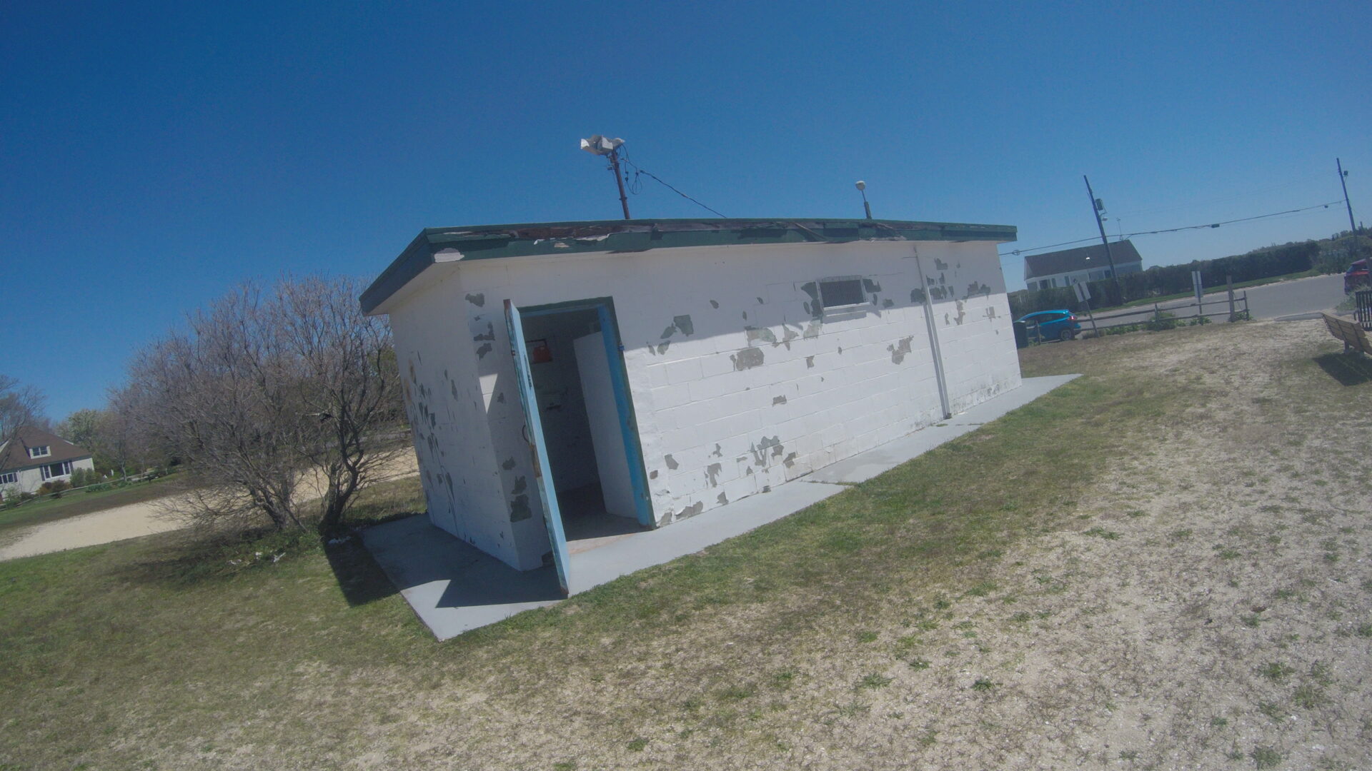 A small white building with a blue door.